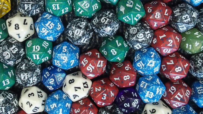 A vibrant collection of colorful 20-sided dice, featuring patterns in blue, red, green, and black, is scattered in a pile. Don't forget; Milton Public Library announces adult programs for November 2024 amidst this kaleidoscope of options!