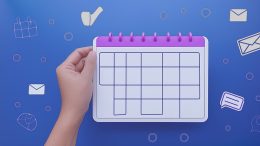 A hand holds a blank calendar page, surrounded by icons like a calendar, envelope, speech bubble, and magnifying glass on a blue background—perfect for planning how to maximize social media engagement for the holiday season. Brought to you by Small Business Corner.