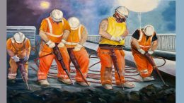 Under the bright winter lights at night, workers in orange vests and helmets use jackhammers at a construction site, reminiscent of an industrial scene from the upcoming Wotiz Gallery exhibit set to take place in March.