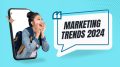 A woman with a backpack is emerging from a phone screen, next to a speech bubble that says "Top 5 Marketing Trends for Small Businesses in 2024," on a blue background. Welcome to Small Business Corner’s sneak peek into the future of marketing!