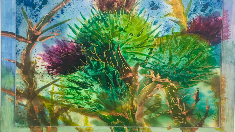 A vibrant watercolor painting of thistles with green and purple hues, set against a blue background, featured in the "From the Beginning: A Journey in the Visual Arts" exhibit at Wotiz Gallery this January.